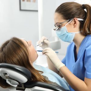 A Woman Doing Dental Examination of Another