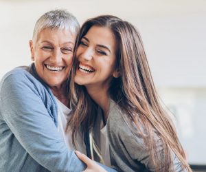 Senior and young women embracing at home